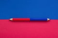 Close-up of a red blue pencil on a background, concept of education Royalty Free Stock Photo