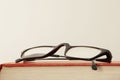 Close up on a red book cover and eye glasses with copy space for your text Royalty Free Stock Photo