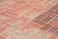Close-up of red brick pavement with a mix of weathered and newer bricks Royalty Free Stock Photo