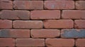 Close up of red brick wall txture with narrow block gaps and hidden mortar.