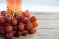 Close-up of red bunch of grapes with bottle of red wine Royalty Free Stock Photo