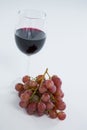 Close-up of red bunch of grapes with glass of red wine Royalty Free Stock Photo