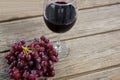 Close-up of red bunch of grapes with glass of red wine Royalty Free Stock Photo