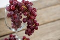 Close-up of red bunch of grapes in wine glass Royalty Free Stock Photo