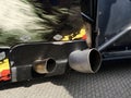 Close up of a red car dual exhaust pipe