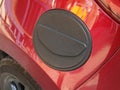 Close-up of a red car with fuel tank cap. Open fuel tank flap Royalty Free Stock Photo