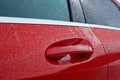 Door of red car with water drops Royalty Free Stock Photo