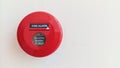 Close-up of red circular fire alarm with manual switch button to warn in case of fire emergency Royalty Free Stock Photo