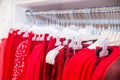 Close up red color Clothes on hangers in shop, butique. Make Outfit set. Shopping Mall. Shopper. Sales. Shopping Center. Selective