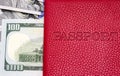 Close up of a red color passport cover with US dollars banknote background