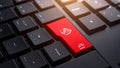 Close-up of a red computer key with a shield icon, representing security and protection. Royalty Free Stock Photo