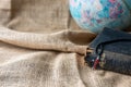 Close up of the red cross on the old holy bible and world globe on vintage linen sack cloth background Royalty Free Stock Photo