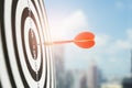 Close up red dart arrow hitting target center dartboard upper deck on background. Business targeting and focus concept Royalty Free Stock Photo