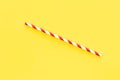 Close up of red drinking straw for party on yellow background, flat lay. Royalty Free Stock Photo