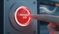 Close up of a red emergency stop button being pressed highlighting industrial safety risk prevention and instant Royalty Free Stock Photo