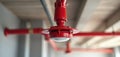 Close-up of red fire sprinkler nozzle mounted on ceiling pipes. Essential component of automatic fast response fire protection Royalty Free Stock Photo