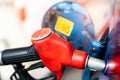 Close-up red fuel nozzle. Gasoline pump nozzle. Car fueling at gas station. Refuel fill up with petrol gasoline. Petrol pump Royalty Free Stock Photo