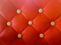 Close up Red genuine leather sofa. Retro chesterfield style