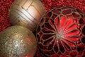 Close-up of Red and Gold Christmas Ornaments on Red Glitter Background Royalty Free Stock Photo