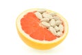 Close up of red grapefruit and pills isolated