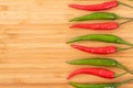 Close up red and green chilli pepper on wood chopping board. Royalty Free Stock Photo