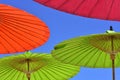 Close-up of a red, green and orange parasol umbrella against the blue sky Royalty Free Stock Photo