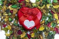 close up of A red heart metal gift box on colorful dried flowers used as wallpaper Royalty Free Stock Photo