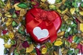 Close up of A red heart metal gift box on colorful dried flowers used as wallpaper Royalty Free Stock Photo