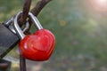 Close up of red heart-shaped love lock hanging on a bridge. Valentine's Day and Love concept. Royalty Free Stock Photo