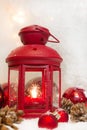 Close up of red lantern with balls and cones for christmas - greeting card first advent