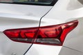 Close-up of a red LED rear brake light replaced after an accident on a white car in the back of a sedan after washing and cleaning Royalty Free Stock Photo