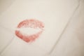Close up of red lipstick kiss on tissue paper.