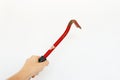 Close-up of red metal nail puller in hand  on white background. Royalty Free Stock Photo