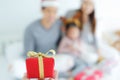 Close up red mini gift box with blur asian family celebration merry christmas Royalty Free Stock Photo