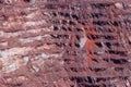 Close-up of red mining levels at iron ore quarry. Open-cast mine, open pit. Background, texture Royalty Free Stock Photo