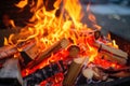 close-up of red and orange flames dancing over firewood Royalty Free Stock Photo