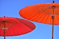 Close-up of a red and orange parasol umbrella against the blue sky Royalty Free Stock Photo