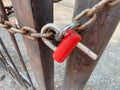 Close-up of red padlock on metallic gate. Old metal gates with lock Royalty Free Stock Photo