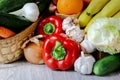 Close-up of red pepper, garlic, cucumber, Iceberg salad, a basket of cucumbers and fresh garlic, bananas and an orange