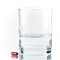 Close up of red pill and water Royalty Free Stock Photo