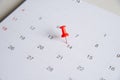 Close up red pin on white calendar Royalty Free Stock Photo