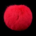 Close up of red rabbit fur pompom isolated on black background Royalty Free Stock Photo