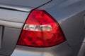 Close-up of a red rear brake light replaced after an accident on a white car in the back of a sedan after washing and cleaning for Royalty Free Stock Photo