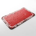 Close-up of a red rectangular object with a textured surface and water droplets isolated on white background Royalty Free Stock Photo