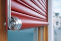 Close-up of a red roller shutter providing security and privacy to a window Royalty Free Stock Photo