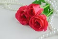 Close up of red rose flowers with white pearls necklace Royalty Free Stock Photo