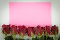Close up of red roses on a wooden background with Blank Message Sign for Your Text or Message. pink Greeting card with a red roses Royalty Free Stock Photo