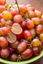 Close up red seedless grapes in a green ceramic bowl Royalty Free Stock Photo