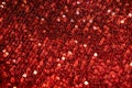 Red sequins background or texture. Sparkling sequined textile