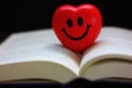 Close up red smiling heart on book ,love reading concept